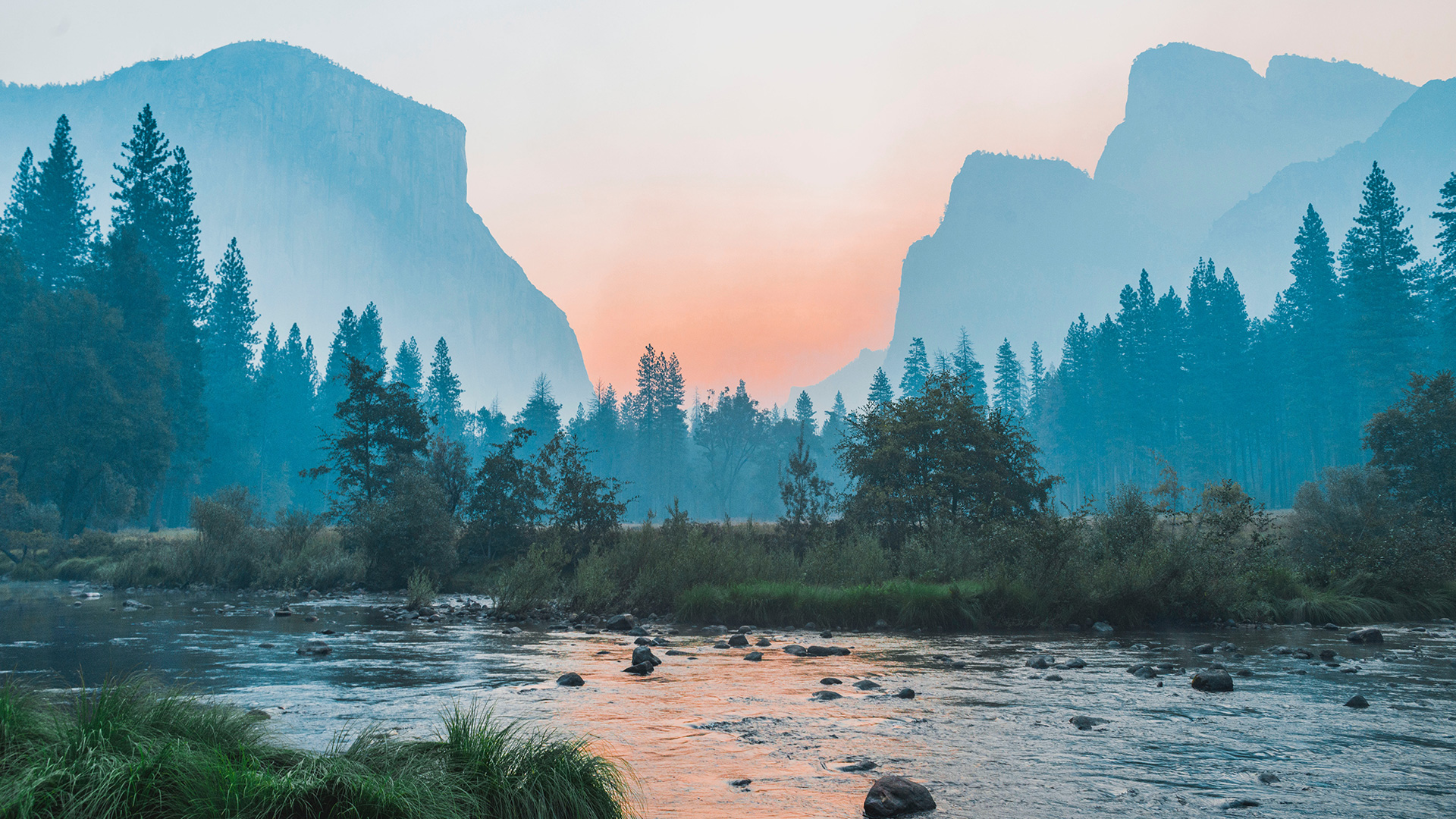 body-of-water-surrounded-by-trees-mountains