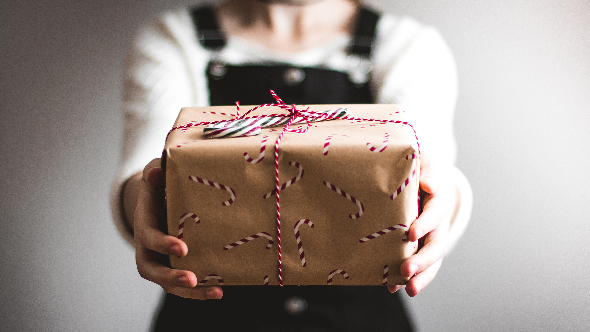 person-showing-brown-gift-box