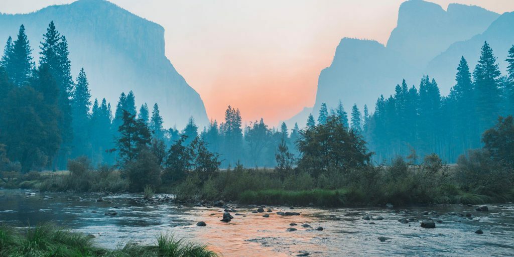 body-of-water-surrounded-by-trees-mountains