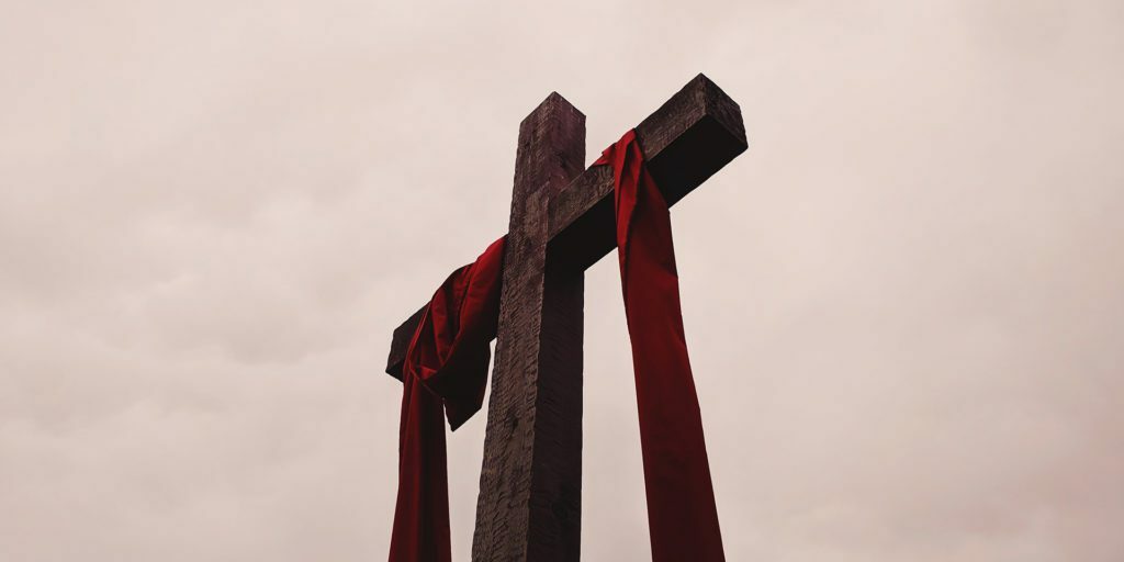 low-angle-view-of-cross-with-red-garment