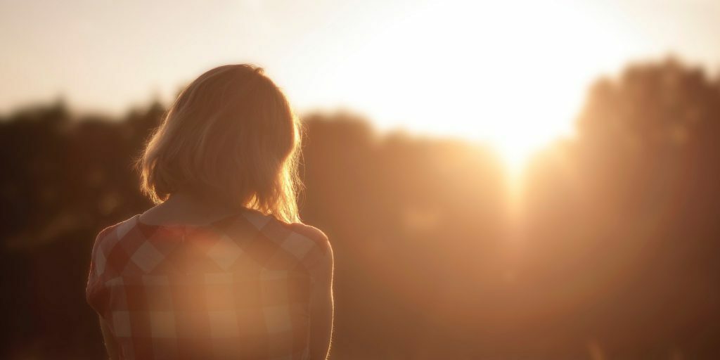 woman-looking-at-trees-at-sunet